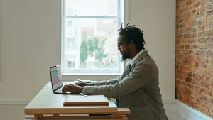 a man using a laptop communicating with a virtual assistant